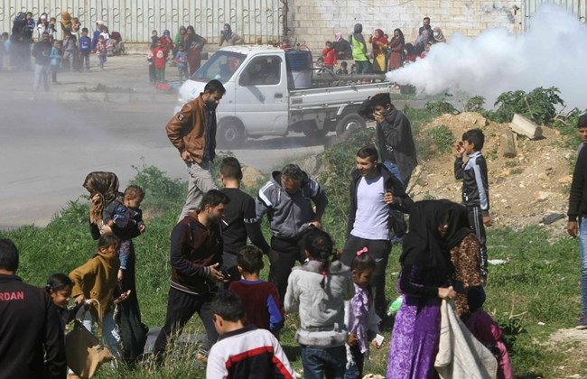 Image of Syrian refugees during fumigation